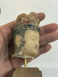 A rare Chinese polychrome carved white marble head of a Bodhisattva on a stand, Northern Qi