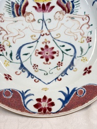 A pair of Chinese famille rose 'Winged Putti' plates, Yongzheng/Qianlong