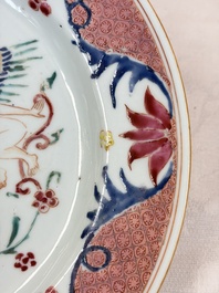 A pair of Chinese famille rose 'Winged Putti' plates, Yongzheng/Qianlong