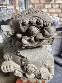 A pair of Chinese carved stone Buddhist lions on later red-lacquered wooden stands, Fujian, Qing