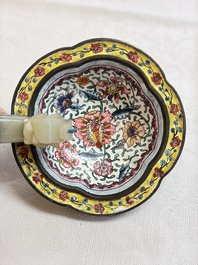 A Chinese celadon jade belt hook mounted as a handle on a Canton enamel bowl, Qing