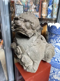 A pair of Chinese carved stone Buddhist lions on later red-lacquered wooden stands, Fujian, Qing