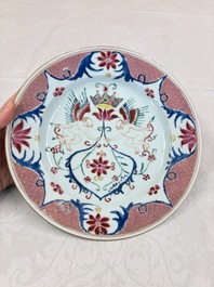A pair of Chinese famille rose 'Winged Putti' plates, Yongzheng/Qianlong