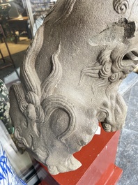 A pair of Chinese carved stone Buddhist lions on later red-lacquered wooden stands, Fujian, Qing