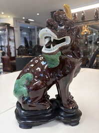 A Chinese sancai-glazed Xiezhi on a wooden stand, 19th C.