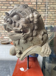 A pair of Chinese carved stone Buddhist lions on later red-lacquered wooden stands, Fujian, Qing