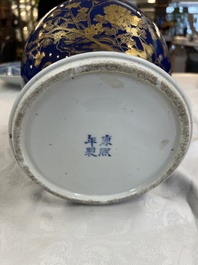 A Chinese gilt-decorated powder-blue-ground vase and cover, Kangxi mark, 19th C.