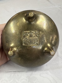 A Chinese bronze two-handled tripod censer, Xuande mark, 19th C.