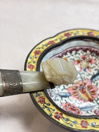 A Chinese celadon jade belt hook mounted as a handle on a Canton enamel bowl, Qing