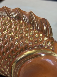 A pair of Chinese coral-red-glazed gilt-decorated 'Goldfish' wall pocket vases on wooden stands, Republic