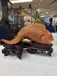 A pair of Chinese coral-red-glazed gilt-decorated 'Goldfish' wall pocket vases on wooden stands, Republic