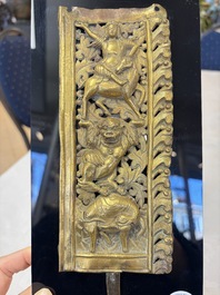 A fine Tibetan gilt-copper repouss&eacute; plaque depicting a Dharmapala, a lion and an elephant, on a later mount, 18th C.