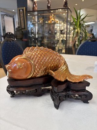 A pair of Chinese coral-red-glazed gilt-decorated 'Goldfish' wall pocket vases on wooden stands, Republic