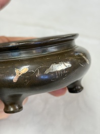 A Chinese or Vietnamese silver-inlaid copper reticulated spherical censer and a silver- and copper-inlaid bronze tripod censer, 19th C.