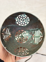 A Chinese or Vietnamese silver-inlaid copper reticulated spherical censer and a silver- and copper-inlaid bronze tripod censer, 19th C.