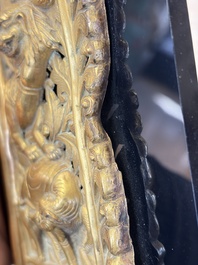 A fine Tibetan gilt-copper repouss&eacute; plaque depicting a Dharmapala, a lion and an elephant, on a later mount, 18th C.