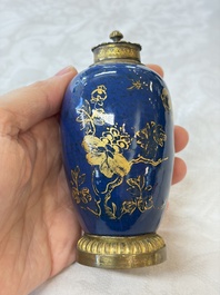 A Chinese powder-blue-ground gilt-decorated spittoon and two gilt-bronze-mounted vases, 18th C.