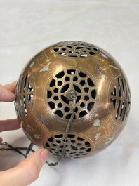 A Chinese or Vietnamese silver-inlaid copper reticulated spherical censer and a silver- and copper-inlaid bronze tripod censer, 19th C.