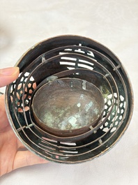 A Chinese or Vietnamese silver-inlaid copper reticulated spherical censer and a silver- and copper-inlaid bronze tripod censer, 19th C.