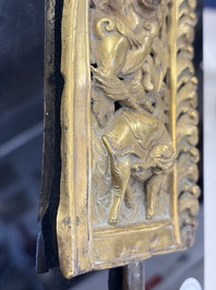 A fine Tibetan gilt-copper repouss&eacute; plaque depicting a Dharmapala, a lion and an elephant, on a later mount, 18th C.