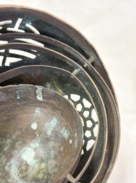 A Chinese or Vietnamese silver-inlaid copper reticulated spherical censer and a silver- and copper-inlaid bronze tripod censer, 19th C.