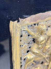 A fine Tibetan gilt-copper repouss&eacute; plaque depicting a Dharmapala, a lion and an elephant, on a later mount, 18th C.