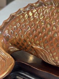 A pair of Chinese coral-red-glazed gilt-decorated 'Goldfish' wall pocket vases on wooden stands, Republic