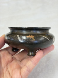 A Chinese or Vietnamese silver-inlaid copper reticulated spherical censer and a silver- and copper-inlaid bronze tripod censer, 19th C.