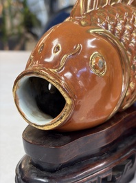A pair of Chinese coral-red-glazed gilt-decorated 'Goldfish' wall pocket vases on wooden stands, Republic
