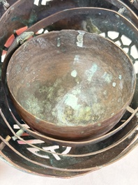 A Chinese or Vietnamese silver-inlaid copper reticulated spherical censer and a silver- and copper-inlaid bronze tripod censer, 19th C.
