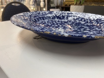 A rare large Nevers white-splashed blue-ground '&agrave; la bougie' dish, France, late 17th C.
