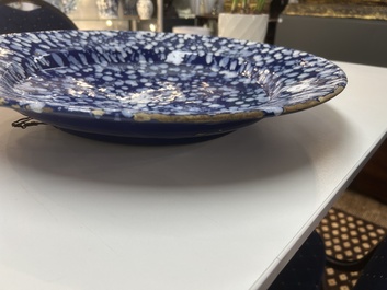 A rare large Nevers white-splashed blue-ground '&agrave; la bougie' dish, France, late 17th C.