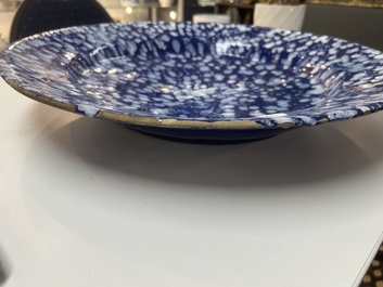 A rare large Nevers white-splashed blue-ground '&agrave; la bougie' dish, France, late 17th C.