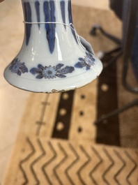 An extremely rare blue, white and manganese Dutch Delft chinoiserie beaker vase after a silver model, late 17th C.
