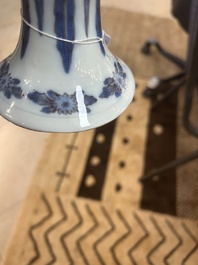 An extremely rare blue, white and manganese Dutch Delft chinoiserie beaker vase after a silver model, late 17th C.