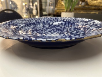 A rare large Nevers white-splashed blue-ground '&agrave; la bougie' dish, France, late 17th C.