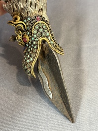 A Tibetan parcel-gilt silver and iron phurba inlaid with precious stones, red coral and bone, 19th C.