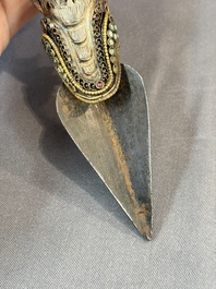 A Tibetan parcel-gilt silver and iron phurba inlaid with precious stones, red coral and bone, 19th C.