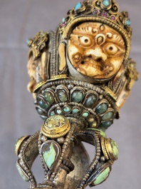 A Tibetan parcel-gilt silver and iron phurba inlaid with precious stones, red coral and bone, 19th C.
