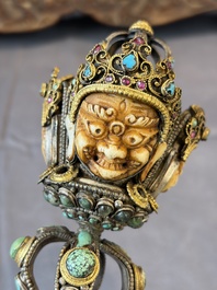A Tibetan parcel-gilt silver and iron phurba inlaid with precious stones, red coral and bone, 19th C.