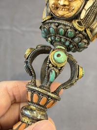 A Tibetan parcel-gilt silver and iron phurba inlaid with precious stones, red coral and bone, 19th C.