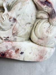 A Chinese stone group of 'Luohan' on wooden stand, Republic