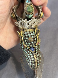 A Tibetan parcel-gilt silver and iron phurba inlaid with precious stones, red coral and bone, 19th C.