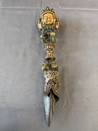 A Tibetan parcel-gilt silver and iron phurba inlaid with precious stones, red coral and bone, 19th C.