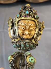 A Tibetan parcel-gilt silver and iron phurba inlaid with precious stones, red coral and bone, 19th C.