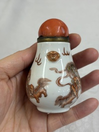 A Chinese gilt-decorated iron-red 'Buddhist Lions' snuff bottle with a red coral stopper, Buddhist Lion mark, Republic
