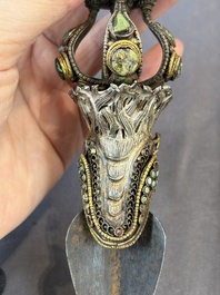 A Tibetan parcel-gilt silver and iron phurba inlaid with precious stones, red coral and bone, 19th C.