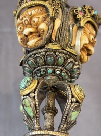 A Tibetan parcel-gilt silver and iron phurba inlaid with precious stones, red coral and bone, 19th C.