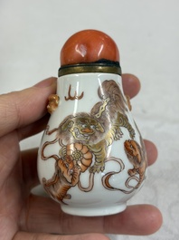 A Chinese gilt-decorated iron-red 'Buddhist Lions' snuff bottle with a red coral stopper, Buddhist Lion mark, Republic