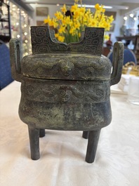 An inscribed Chinese archaic bronze food vessel and cover with double-dragon design, 'Yu Fang Ding 圉方鼎', Western Zhou
